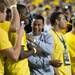 Former Michigan basketball player Trey Burke jokes with his old team mates on the sidelines of Michigan Stadium during the Wolverines, Notre Dame game, Saturday, Sept. 7. 
Courtney Sacco I AnnArbor.com 