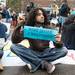 A protester sits in the intersection of South State Street and South University Avenue in Ann Arbor demanding tuition equality for unauthorized immigrants.
Courtney Sacco I AnnArbor.com