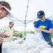 Greta form Ed's Bread puts out a cinnamon stick for a customer at Pittsfield Township's Farmers Market Thursday, June 13.Courtney Sacco I AnnArbor.com 