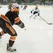 The Falcons defensemen Connor Kucera tries to get the puck out of his zone against the Wolverines during the first period, Tuesday Jan. 8.
Courtney Sacco I AnnArbor.com  