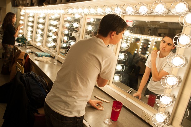 Looking in the mirror, Huron High School student Matt Egeler puts on his makeup as he prepares for the dress rehearsal of "The Musical Comedy Murders of 1940."
Courtney Sacco I AnnArbor.com