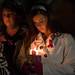 Jennifer Niswender holds a candle as she remembers her twin sister during a vigil held at EMU's Big Bob's Lake house Friday evening.
Courtney Sacco I AnnArbor.com 