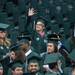 An undergraduate student waves as the students take their seats during the processional.
Courtney Sacco I AnnArbor.com  