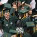 An undergraduate student waves as the students take their seats during the processional.
Courtney Sacco I AnnArbor.com  