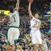 Wolverines sophomore Trey Burke  shoots a a basket against EMU'S Da'Shonte Riley during Thursday Nights game.Courtney Sacco I AnnArbor.com 