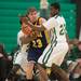 Huron's Demetrius Sims and Zaviar Cochran defend against Chelsea's Luke Hollandsworth during Friday nights game at Huron High School. 
Courtney Sacco I AnnArbor.com 