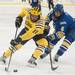Wolverines left wing Andrew Copp tries to skate past Nanoks Michael Quinn during the second period of their game at the Yost Ice Arena Saturday Jan. 12.
Courtney Sacco I AnnArbor.com   