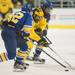 Wolverines left wing Luke Moffatt tries to brake away form the Nanooks Josh Atkinson and Nolan Huysmans during the third period of their game at the Yost Ice Arena Saturday Jan. 12.
Courtney Sacco I AnnArbor.com     