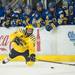 Wolverines right wing Andrew Sinelli tries to pass the puck form his knees during the third period of their game against the Alaska Nanooks at the Yost Ice Arena Saturday Jan. 12.
Courtney Sacco I AnnArbor.com     