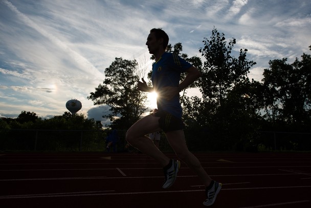 Olympian Nick Willis worms up on Saline High School track before trying to beat the recored for the fastest mile run in Michigan, Sunday, August, 4.
Courtney Sacco I AnnArbor.com