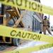 Laborer Joe Kennedy watches coworkers remove the Borders sign from the building on Liberty Street on Monday Dec. 31. Daniel Brenner I AnnArbor.com