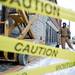 Laborer Joe Kennedy watches coworkers remove the Borders sign from the building on Liberty Street on Monday Dec. 31. Daniel Brenner I AnnArbor.com