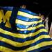 Michigan fans lift a flag at Crisler Arena on Monday, April 8. Daniel Brenner I AnnArbor.com