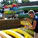 Canoe Livery employee Jacob Graff unstrings single kayaks at Gallup Park during Huron River Day on Sunday, July 14. This is his first year working at Gallup Park. Daniel Brenner I AnnArbor.com