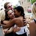 Friends hug Becca Amidei after performing on the acoustic stage during the Live on Washington Music and Arts Festival on Saturday, June 1. Daniel Brenner I AnnArbor.com