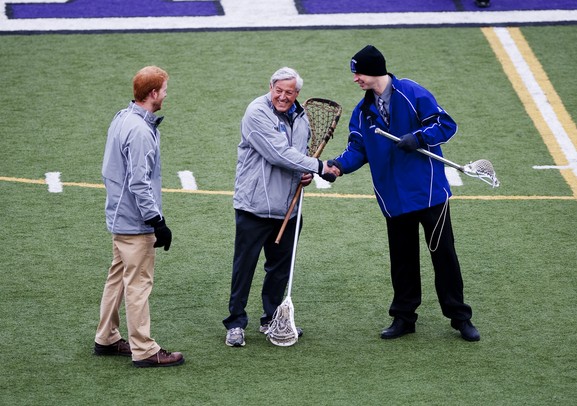 Head coaches  Jack Robenalt and Smith Altwood shake hands before the game on Friday, April 12. Skyline consultant Dr. James "Gil" Leaf presented the teams with a Native America lacrosse stick that will act as a traveling trophy for the two teams. AnnArbor.com I Daniel Brenner