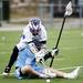 Pioneer senior Dylan Graham reaches over Skyline Eric Guldberg for a loose ball on Friday, April 12. AnnArbor.com I Daniel Brenner