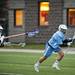 Skyline Dan Lee runs behind the net with the ball in the game against Pioneer on Friday, April 12. AnnArbor.com I Daniel Brenner