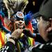 Wisconsin resident Adlai Cleveland, 8, receives assistance from his uncle Rick at Dance for Mother Earth Powwow on Saturday, April 6. Daniel Brenner I AnnArbor.com