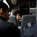 New Tech High School junior Isaiah Mahler talks with other students during a bus ride at the Willow Run Airport tour in Ypsilanti on Tuesday, March 26. Daniel Brenner I AnnArbor.com