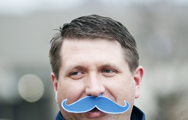Ann Arbor resident and season ticket holder Kelly Cox wears a fake mustache for Movember men's health awareness month on Saturday. Daniel Brenner I AnnArbor.com
