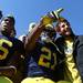 Fans celebrate with Kevin Koger,left, and Junior Hemingway as Michigan took on the University of Minnesota Saturday October 1, 2011. Michigan won the game 58-0 Jeff Sainlar I AnnArbor.com 
