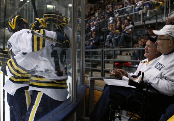 Jim Diana(furthest away) and Terry Brown get an upclose view of Michigan's goal celebration as Michigan took on Niagara University in their season opener at Yost Ice Arena Tuesday October, 4, 2011. Michigan won the match 5-0. Jeff Sainlar I AnnArbor.com
