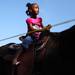 Tiana Priester,4, is a little scared when first swetting off on the pony at the "Meet on the Street Community Block Party," out in front of Grace Fellowship Church in Ypsilanti  Saturday October 8, 2011. Pastor Willie J. Powell of Grace Fellowship Church along with Pastor Julianne Smeck of St. Mark Lutheran Church decided to put this on together to connect the communities. Jeff Sainlar I AnnArbor.com