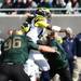 Michigan's Denard Robinson is sandwiched by two Spartans as Michigan took on Michigan State Saturday October 15, 2011 at Spartan Stadium. Michigan State won the game 28-14.  Jeff Sainlar I AnnArbor.com