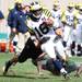 Michigan's Denard Robinson tries to run through a defender as Michigan took on Michigan State Saturday October 15, 2011 at Spartan Stadium. Michigan State won the game 28-14.  Jeff Sainlar I AnnArbor.com