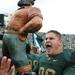 Michigan State Defensive lineman Kevin Pickelman celebrates with the Paul Bunyan Trophy. It was the fourth time Pickleman had defeated the Wolverines. Michigan State won the game 28-14.  Jeff Sainlar I AnnArbor.com