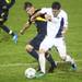 Michigan's Adam Shaw(left) and Eric Stevenson fight for control of the ball as the Michigan Wolverines took on the Akron Zips Tuesday, Oct. 18, 2011 at the Michigan Soccer Complex. Michigan defeated the No. 4 Zips, 1-0, in overtime.  Jeff Sainlar I AnnArbor.com