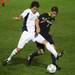 Akron's Reinaldo Brenes(left) and Adam Shaw battle over the ball as the Michigan Wolverines took on the Akron Zips Tuesday, Oct. 18, 2011 at the Michigan Soccer Complex. Michigan defeated the No. 4 Zips, 1-0, in overtime.  Jeff Sainlar I AnnArbor.com