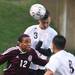 Pioneer's Josh Graves heads it over Dante Violette as Pioneer High School took on University of Detroit Jesuit  at Saline High School Wednesday October 26, 2011. Pioneer won the game 5-1 to advance to the next round. Jeff Sainlar I AnnArbor.com