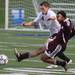 Pioneer's Chase Pagani  tries to get the ball before Dante Violette's slide tackle as Pioneer High School took on University of Detroit Jesuit  at Saline High School Wednesday October 26, 2011. Pioneer won the game 5-1 to advance to the next round. Jeff Sainlar I AnnArbor.com