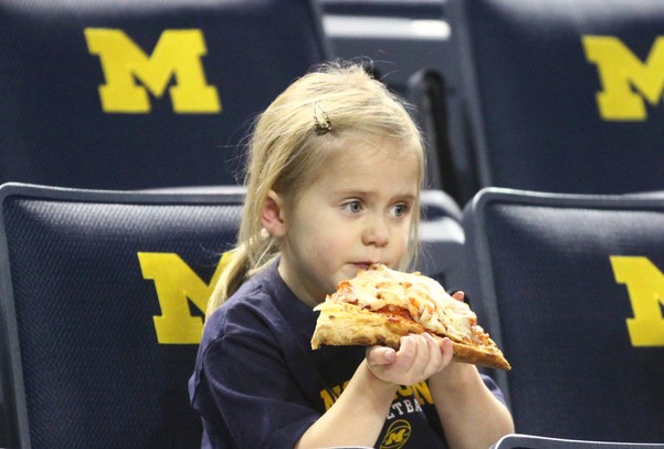 Thora Crawford enjoys a slice of pizza as Michigan took on Ferris State at the Crisler Arena Friday November 11, 2011.Michigan won the game 59-33. (AP Photo/AnnArbor.com, Jeff Sainlar I AnnArbor.com)