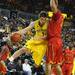 Michigan's Stu Douglass passed around Jerrell Sanders as Michigan took on Ferris State at the Crisler Arena Friday November 11, 2011. (AP Photo/AnnArbor.com, Jeff Sainlar I AnnArbor.com)as Michigan 