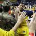 A Michigan player runs through the Maize Rage as Michigan took on Ferris State at the Crisler Arena Friday November 11, 2011. (AP Photo/AnnArbor.com, Jeff Sainlar I AnnArbor.com)