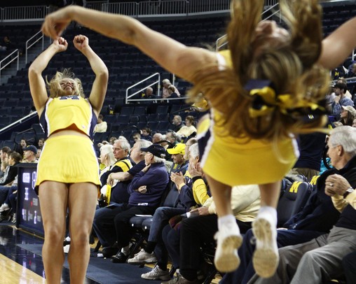 Michigan cheerleaders do backflips as the University of Michigan men's basketball team took on Western Illinois Thursday November 17, 2011 at the Crisler Arena. Michigan won the game 59-55. Jeff Sainlar I AnnArbor.com
