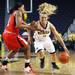 Michigan's Courtney Boylan dribbles by Janita Badon as the University of Michigan women's basketball team took on the University of Utah Utes Thursday November 17, 2011 at the Crisler Arena. Jeff Sainlar I AnnArbor.com