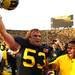 Ryan Van Bergen celebrates with fans after they stormed the field in the Michigan vicotry as the University of Michigan took on Ohio State Saturday  November 26, 2011 at Michigan Stadium. Michigan won the game 40-34. Jeff Sainlar I AnnArbor.com