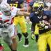Fitzgerald Toussaint tries to evade a tackle from John Simon as the University of Michigan took on Ohio State Saturday  November 26, 2011 at Michigan Stadium. Michigan won the game 40-34. Jeff Sainlar I AnnArbor.com