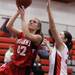 Whitmore's Melissa Dreffs goes up for a layup over Allison Sotomayor as Milan took on Whitmore Lake at Milan High School Tuesday November 29, 2011. Milan won the game 36-33.  Jeff Sainlar I AnnArbor.com