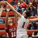 Milan's Corinna Schneider gets a hand on Marta Formoso Prada's shot as Milan took on Whitmore Lake at Milan High School Tuesday November 29, 2011. Milan won the game 36-33.  Jeff Sainlar I AnnArbor.com