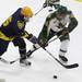 Captain Wes Cimmarrusti(left) and Matt Rupprecht go after the puck as Ann Arbor Huron took on Grosse Pointe South  Wednesday November 30, 2011 at the Ann Arbor Ice Cube. Grosse Pointe South won 8-1. Jeff Sainlar I AnnArbor.com