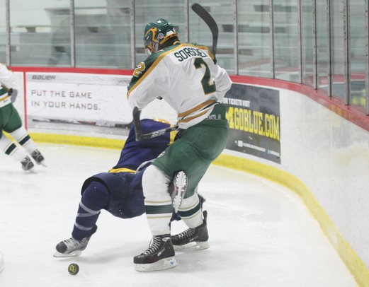 Huron's Nick Sorsher lays out a Grosse Point South player as Ann Arbor Huron took on Grosse Pointe South  Wednesday November 30, 2011 at the Ann Arbor Ice Cube. Grosse Pointe South won 8-1. Jeff Sainlar I AnnArbor.com