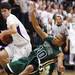 Pioneer captain Gabe Isa(left) and Kamari Davis collide during a play as Ann Arbor Pioneer took on Father Gabriel Richard  Tuesday  December 6, 2011 at Pioneer High School. Pioneer won the game 70-34. Jeff Sainlar I AnnArbor.com