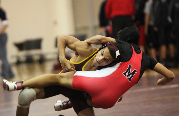 Manchester's Robert Stamp takes down Milan's Xena Pennington as Saline, Manchester, Clinton, and Milan participated in a quad meet Wednesday  December 7, 2011 at Manchester High School. Jeff Sainlar I AnnArbor.com