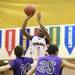 Ypsilanti's Xavier Higgins shoots it over Pioneer defenders as Ann Arbor Pioneer took on Ypsilanti Friday December 9, 2011 at Ypsilanti High School. Ypsilanti won the game convincingly 70-38. Jeff Sainlar I AnnArbor.com