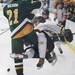 Lumen Christi's Mike Wilson lays out Brody Layher as Chelsea High School took on Jackson Lumen Christi Wednesday December 14, 2011 at the Chelsea Arctic Coliseum. Chelsea won 6-5.  Jeff Sainlar I AnnArbor.com